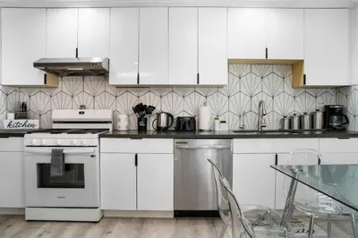 a kitchen with white appliances and a glass table at Marbella Lane - Your Cozy Haven 2BR Retreat in West Covina