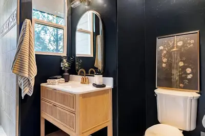 a bathroom with a sink and a mirror and a toilet at Lakeview Mountain Modern in Lake Arrowhead