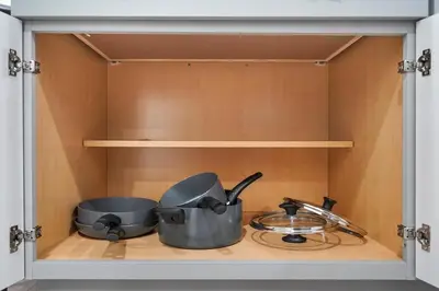 a cabinet with two pots and pans in it at 1 mile from the Beach Fire Pit, Patio, Parking! in Long Beach