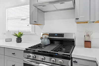 a kitchen with a stove with a tea kettle on it at 1 mile from the Beach Fire Pit, Patio, Parking! in Long Beach