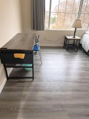 a room with a wooden table and a room with a bed at Big quiet bedroom in Hacienda Heights