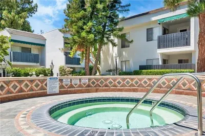a small pool in a courtyard in front of a building at A Tranquil Retreat in Tarzana CA in Tarzana