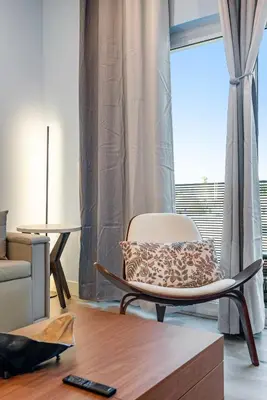 a living room with a chair and a window at Brand New 2BR Loft near Universal & Hollywood in Los Angeles