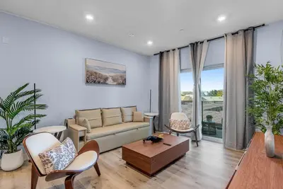 a living room with a couch and a table at Brand New 2BR Loft near Universal & Hollywood in Los Angeles