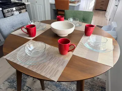 a wooden table with red cups and bowls on it at Welcome To The Modern Casita Riverside! in Riverside