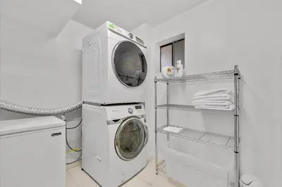 a laundry room with a washing machine and a washer at Arrowbear Retreat - EV Charging, Generator, Arcade in Arrowbear Lake