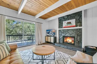a living room with a couch and a fireplace at Arrowbear Retreat - EV Charging, Generator, Arcade in Arrowbear Lake