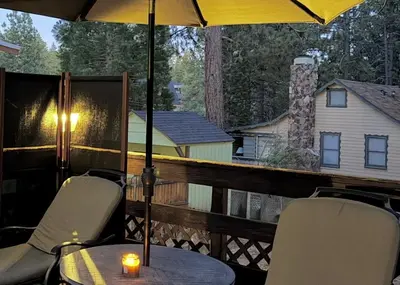 a table and chairs on a deck with an umbrella at The Highpoint - Close to Lake/Village, Fireplace, Smart TV, Hammock, BBQ in Big Bear Lake