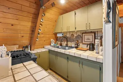 a kitchen with a sink and a stove at The Highpoint - Close to Lake/Village, Fireplace, Smart TV, Hammock, BBQ in Big Bear Lake