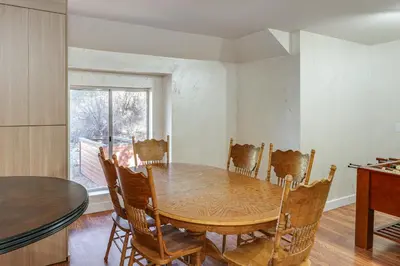 a dining room with a wooden table and chairs at Games Galore! Pine Mountain Club Retreat Near Town in Pine Mountain Club