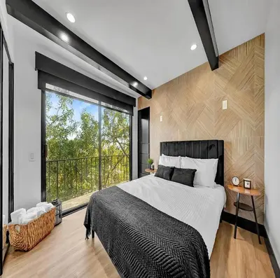a bedroom with a large bed and a large window at Skyview Estate in Los Angeles