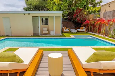 a swimming pool with two beds in a backyard at Relaxing 4BR LA Home Private Pool & Fire Pit in Los Angeles