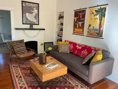 a living room with a couch and a coffee table at Charming Boho Pasadena Cottage Near Rose Bowl in Pasadena