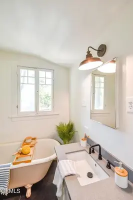 a white bathroom with a tub and a sink at Charming Boho Pasadena Cottage Near Rose Bowl in Pasadena