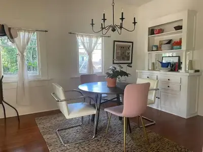 a dining room with a table and chairs at Charming Boho Pasadena Cottage Near Rose Bowl in Pasadena