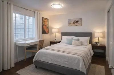a bedroom with a bed and a desk and a window at Irolo Guesthouse in Los Angeles