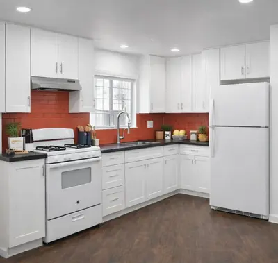a kitchen with white cabinets and a white refrigerator at Irolo Guesthouse in Los Angeles