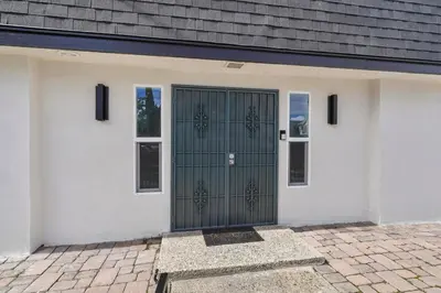a garage with a green door on a house at Walk to Shoreline Village, BBQ in Prime Location in Long Beach