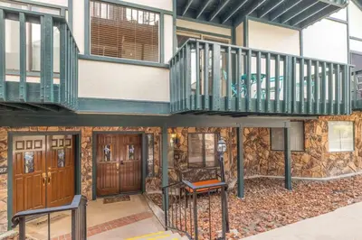 a house with a balcony and a staircase at Lakeview Getaway Game Rm, Pool, Spa, Sauna! in Big Bear Lake