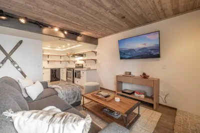 a living room with a couch and a table at Lakeview Getaway Game Rm, Pool, Spa, Sauna! in Big Bear Lake