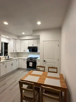 a kitchen with a wooden table and chairs in it at Brand New Muji Style 3B3B Retreat with Courtyard in Walnut