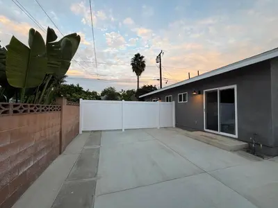 a backyard of a house with a white fence at Brand New Muji Style 3B3B Retreat with Courtyard in Walnut