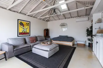 a living room with a couch and a table at Lovely Culver City Home 8 Mins to Beach Close to LAX in Los Angeles