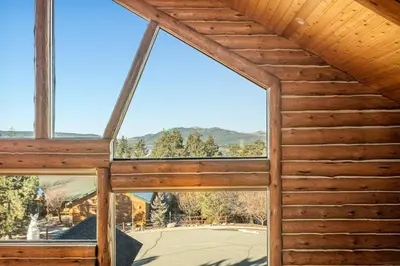 a view from the inside of a building with windows at Hawk Ridge Chalet In Big Bear Lake in Big Bear Lake
