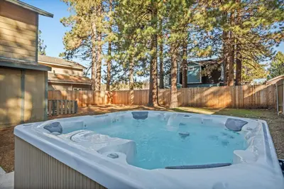 a hot tub in the backyard of a house at Live Love Lake in Big Bear Lake