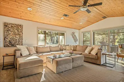a living room with a couch and a ceiling fan at Live Love Lake in Big Bear Lake