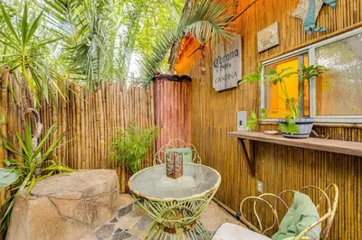 a patio with a table and some plants and a fence at 2 Mi to Echo Park Funky Silver Lake Studio in Los Angeles