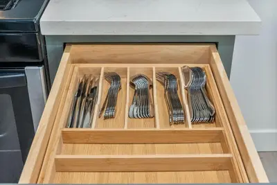 a wooden drawer filled with forks and spoons at Luxe 3BR South Bay - Comfort and Close to Beach in Harbor City