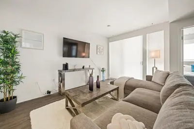 a living room with a couch and a table at Heart of Santa Monica Chic Condo in Los Angeles