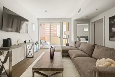 a living room with a couch and a table at Heart of Santa Monica Chic Condo in Los Angeles