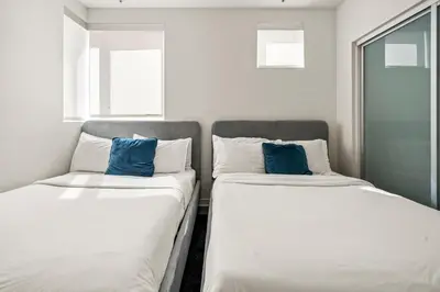 two beds sitting next to each other in a room at Heart of Santa Monica Chic Condo in Los Angeles