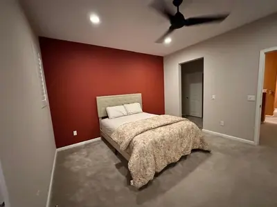 a bedroom with a bed and a red wall at Luxury 2 Bed 2 bath Home Near Six Flags in Santa Clarita