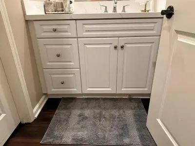 a bathroom with a white sink and a bathroom rug at Luxury 2 Bed 2 bath Home Near Six Flags in Santa Clarita