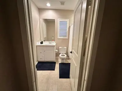 a bathroom with a sink and a toilet and a mirror at Luxury 2 Bed 2 bath Home Near Six Flags in Santa Clarita