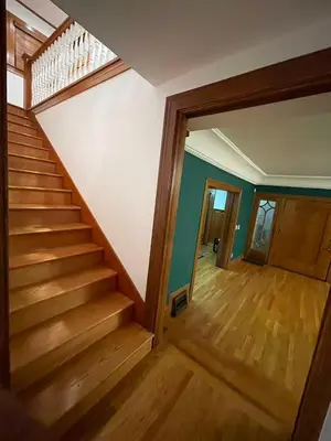 a staircase in a home with wooden floors and a hallway at Hollywood Heritage Villa in Los Angeles