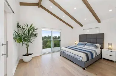 a bedroom with a bed and a potted plant at Beautiful home with VIEWS in Silver Lake Hills in Los Angeles