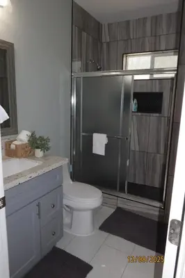 a bathroom with a shower with a toilet and a sink at Welcome to A new updated 3 bedroom 2 Bath Home in California City