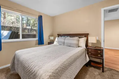 a bedroom with a bed and a window at Appleview - Walk to Village/Lake, Lake View, Hot Tub, BBQ in Big Bear Lake