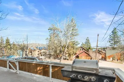 a grill sitting on top of a fence at Appleview - Walk to Village/Lake, Lake View, Hot Tub, BBQ in Big Bear Lake