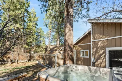 a hot tub in a yard next to a house at Appleview - Walk to Village/Lake, Lake View, Hot Tub, BBQ in Big Bear Lake