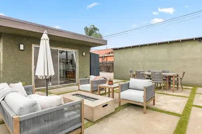 a patio with a table and chairs and an umbrella at Casa Verde in Inglewood