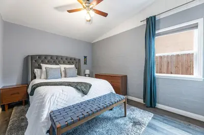 a bedroom with a bed with a ceiling fan and a window at Casa Verde in Inglewood