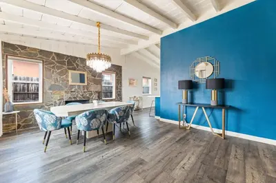 a dining room with blue walls and a table and chairs at Casa Verde in Inglewood