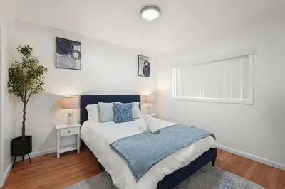a bedroom with a large bed and a window at Steps to Beach - Beach Essentials Provided! in Long Beach
