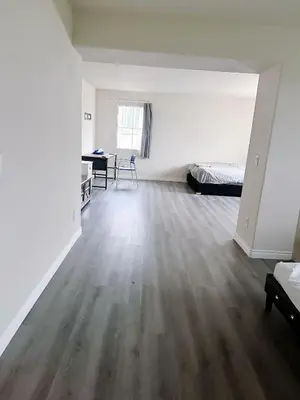 an empty room with a bed and a desk at Big master bedroom private bathroom in Fontana