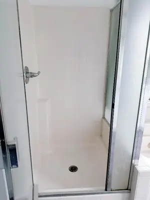 a shower with a glass door in a bathroom at Big master bedroom private bathroom in Fontana